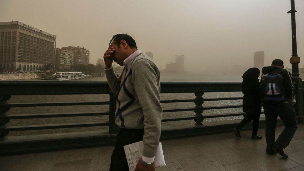 People walk on a bridge during a sandstorm in Cairo, Egypt, Feb. 10, 2015.
