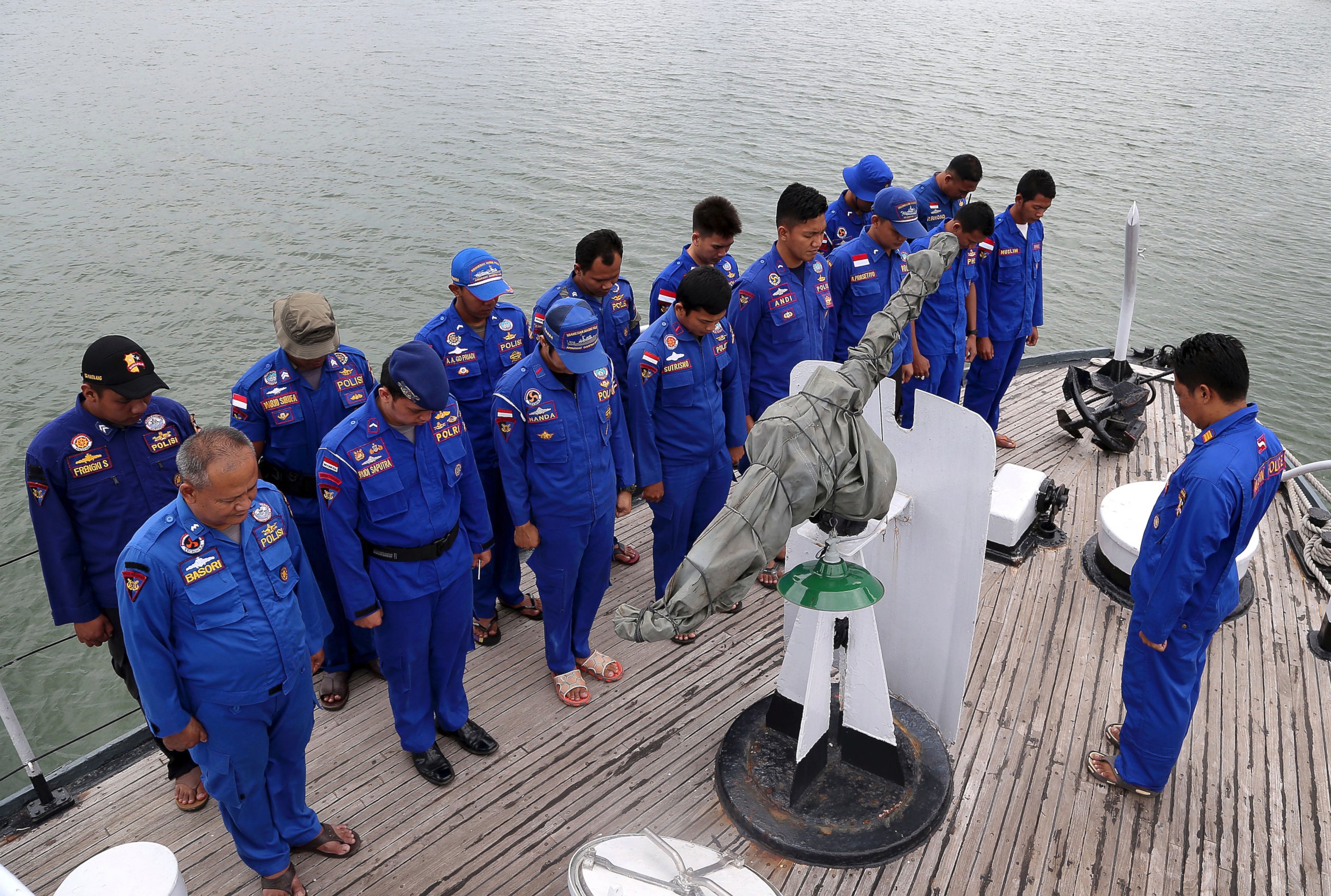 PHOTO: Members of Indonesia's Marine Police pray on board a search and rescue ship before a search operation for the missing AirAsia flight 8501, at Pangkal Pinang port in Sumatra Island, Dec. 29, 2014 in Indonesia.