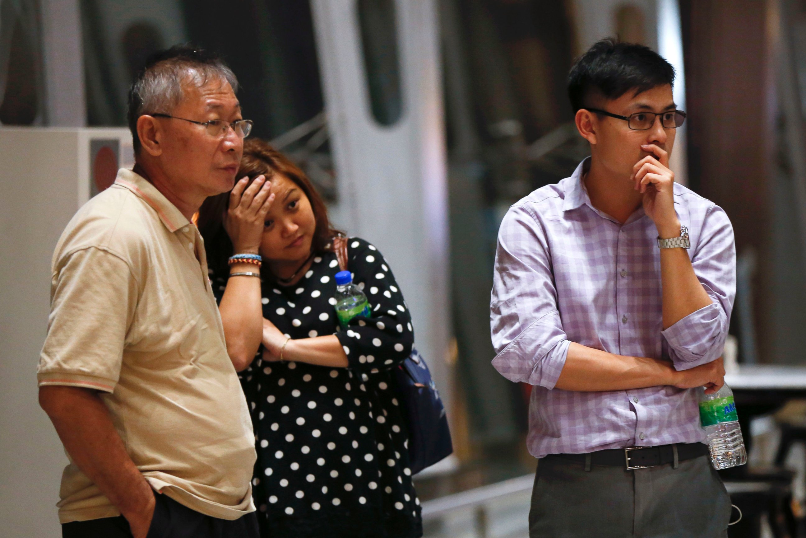 PHOTO: People at Kuala Lumpur International Airport, in Sepang, Malaysia, wait for news after a Malaysia Airlines plane crashed in eastern Ukraine, July 18, 2014.