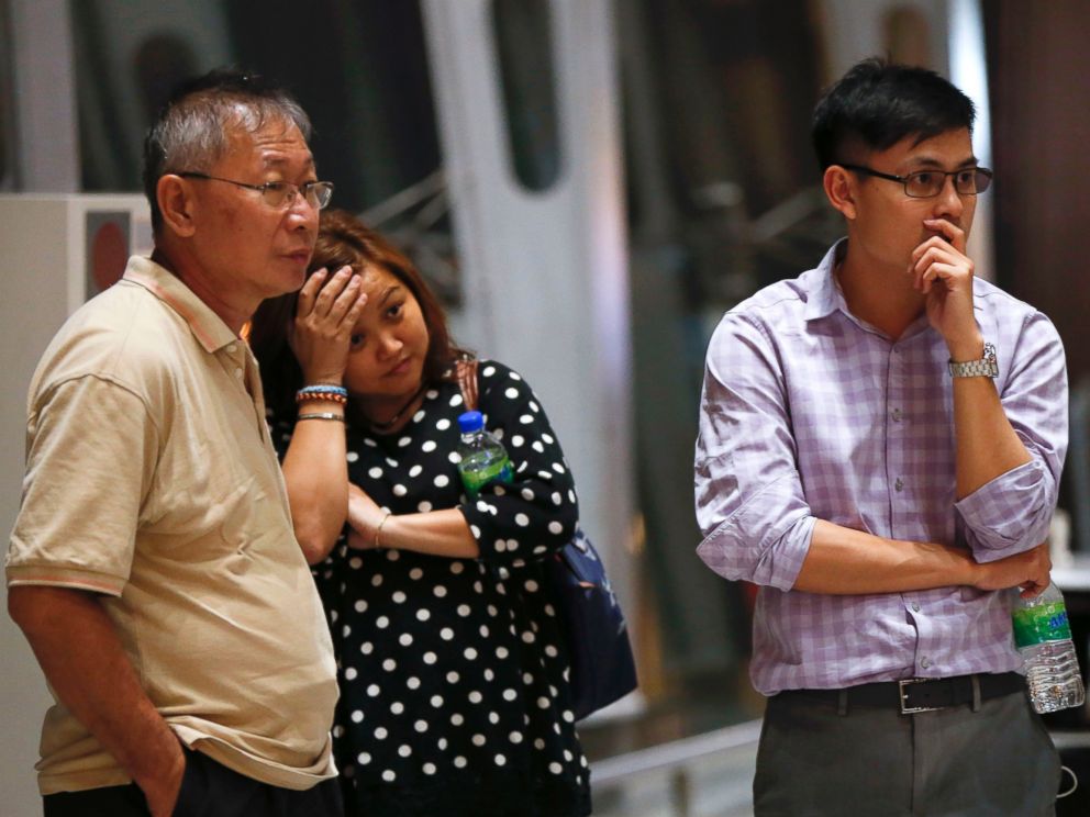 PHOTO: People at Kuala Lumpur International Airport, in Sepang, Malaysia, wait for news after a Malaysia Airlines plane crashed in eastern Ukraine, July 18, 2014.