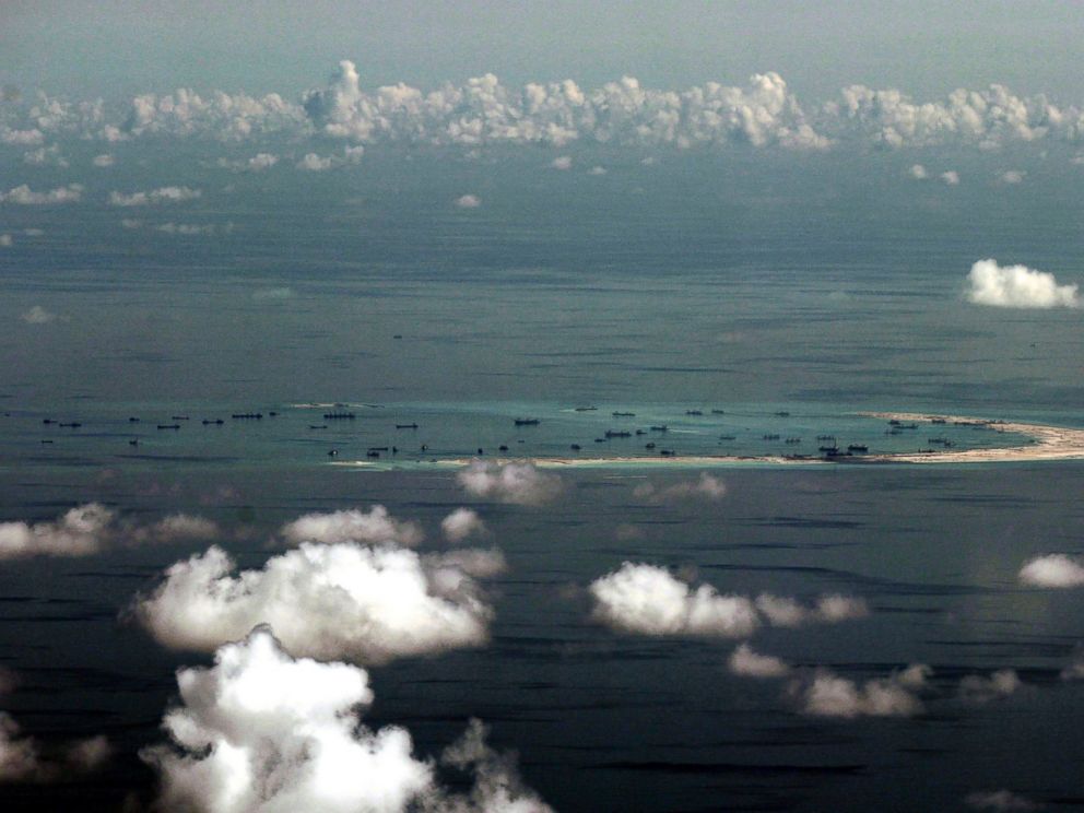 PHOTO: In this May 11, 2015, file photo, this aerial photo taken through a glass window of a military plane shows Chinas alleged on-going reclamation of Mischief Reef in the Spratly Islands in the South China Sea.