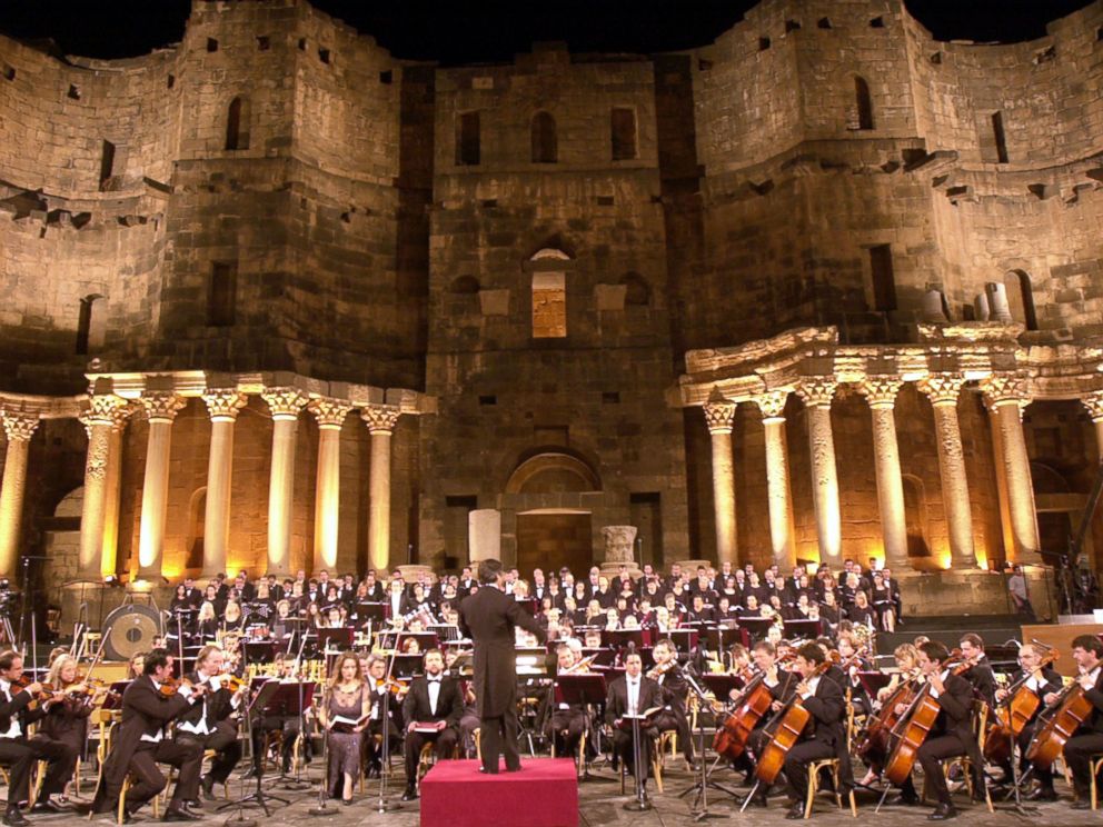 PHOTO:The Italian maestro, Ricardo Muti, leading late Sunday, July 25, 2004, more than 300 singers and musicians at the roman Bosra stadium, which was built 2,000 years ago in Daraa province, south of Damascus and accommodates some 16,000 people.