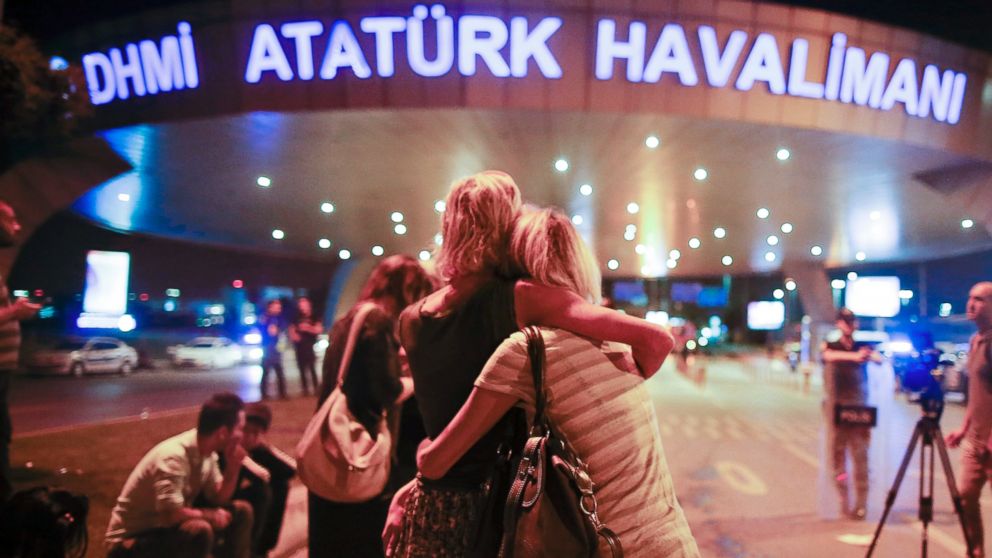 Passengers embrace each other at the entrance to Istanbul's Ataturk airport, early Wednesday, June 29, 2016 following their evacuation after a blast. Suspected Islamic State group extremists have hit the international terminal of Istanbul's Ataturk airport, killing dozens of people and wounding many others, Turkish officials said Tuesday. Turkish authorities have banned distribution of images relating to the Ataturk airport attack within Turkey. 