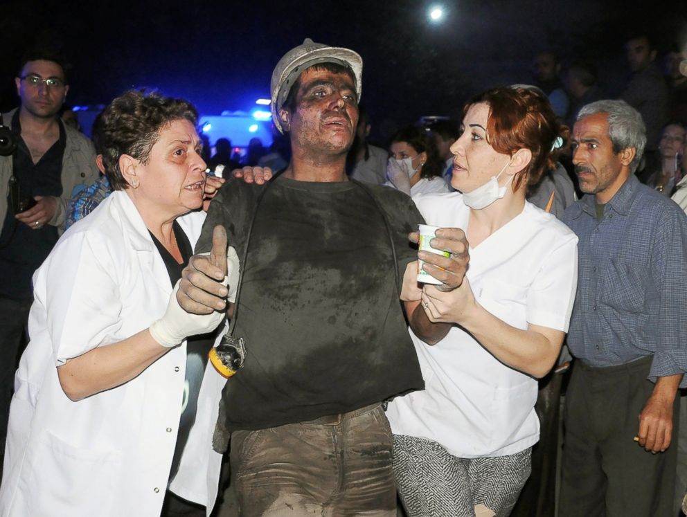 PHOTO: Medics help a rescued miner after an explosion and fire at a coal mine in Soma, western Turkey, May 13, 2014.