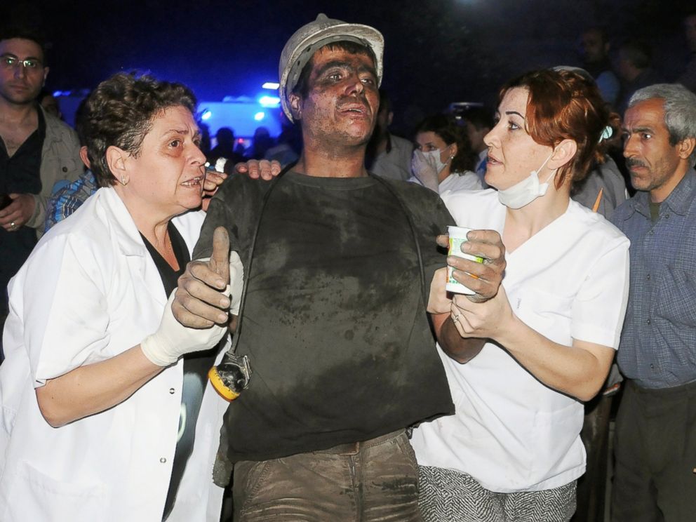 PHOTO: Medics help a rescued miner after an explosion and fire at a coal mine in Soma, western Turkey, May 13, 2014.