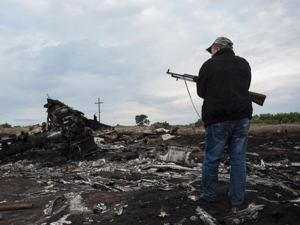 PHOTO: A pro-Russia fighter stands on guard the crash site of a Malaysia Airlines jet near the village of Hrabove, eastern Ukraine, Saturday, July 19, 2014.