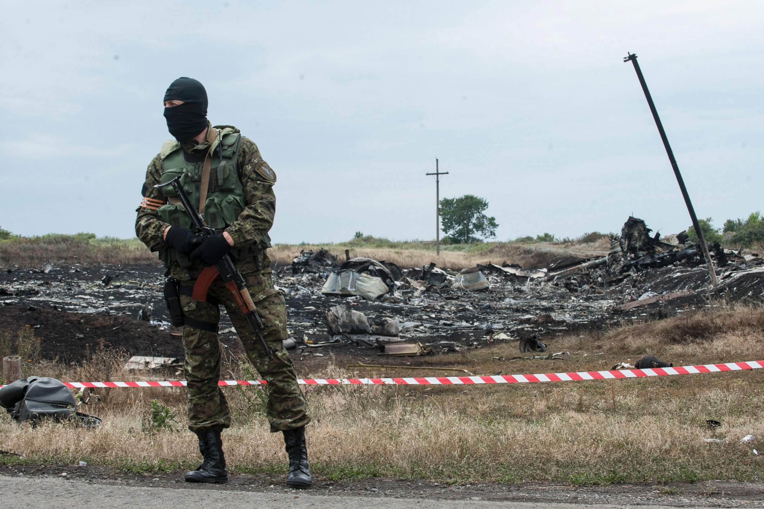 PHOTO: A pro-Russian fighter guards the crash site of a Malaysia Airlines jet near the village of Hrabove, eastern Ukraine, Saturday, July 19, 2014.