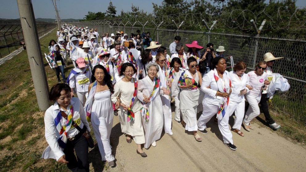 PHOTO: Gloria Steinem, Mairead Maguire, Leymah Gbowee, and other activists march to the Imjingak Pavilion with South Korean activists along the military wire fences near the border village of Panmunjom, in Paju, north of Seoul, South Korea, May 24, 2015.