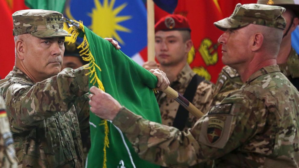 Commander of the International Security Assistance Force (ISAF), Gen. John Campbell, left, and Command Sgt. Maj. Delbert Byers open the "Resolute Support" flag during a ceremony at the ISAF headquarters in Kabul, Afghanistan, Dec. 28, 2014. 