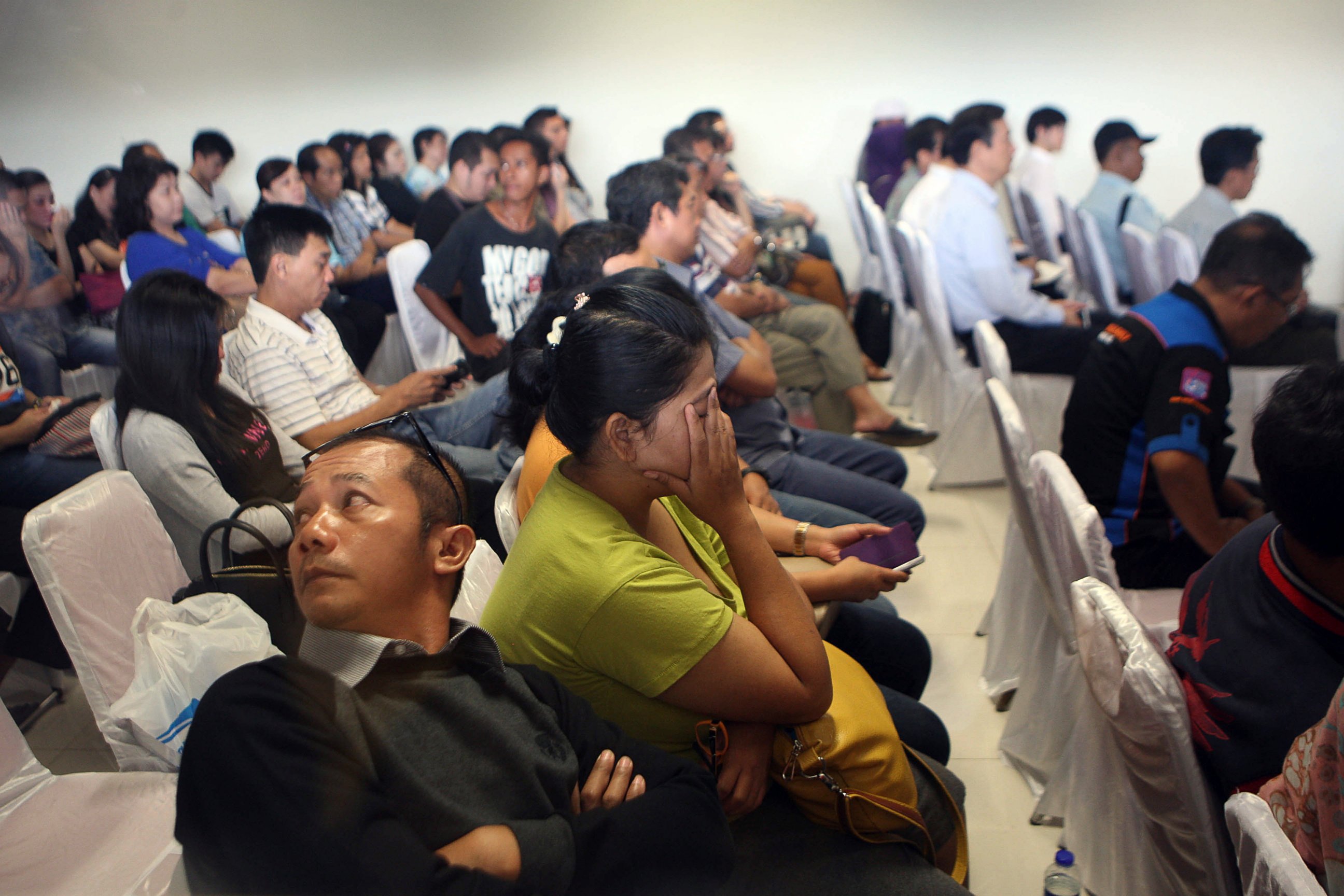 PHOTO: Relatives and next-of-kin of passengers on the AirAsia flight QZ8501 wait for the latest news