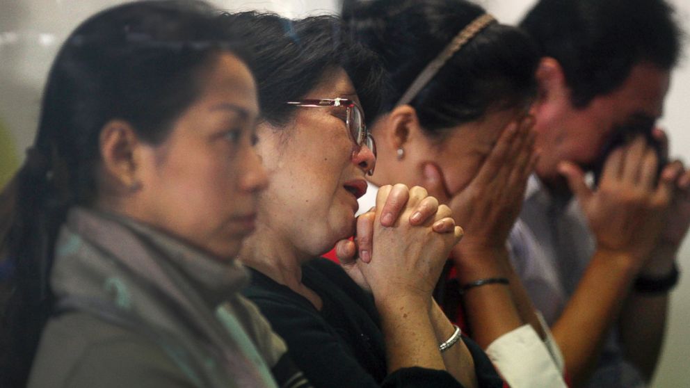 Relatives and next-of-kin of passengers on the AirAsia flight QZ8501 wait for the latest news on the search of the missing jetliner at Juanda International Airport in Surabaya, East Java, Indonesia, Dec. 29, 2014. 