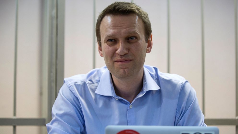 Russian opposition activist and anti-corruption crusader Alexei Navalny smiles in a court room in Moscow, Russia, Dec. 19, 2014.