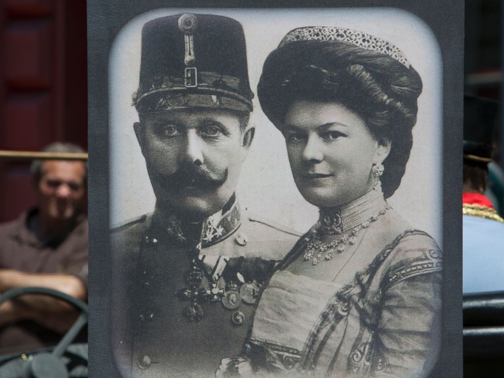 PHOTO: Tourists look at exhibits in Sarajevo museum, including portraits of Archduke Franz Ferdinand and Sofia von Hochenberg, in Sarejevo, Saturday, June 28, 2014.