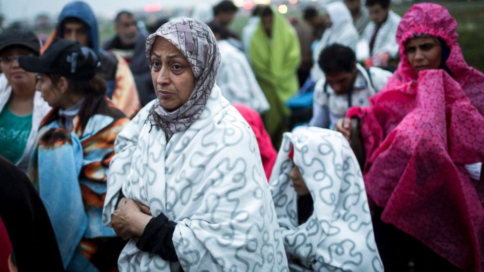 Refugees walk in the rain on the Austrian side of the Hungarian-Austrian border near Nickelsdorf after they crossed the border from Hungary, Sept. 5, 2015. 
