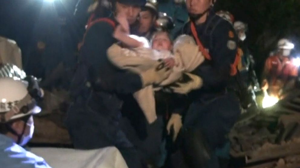Miku Nishimura, an 8-month-old baby, is carried away after being rescued from a collapsed home after a magnitude-6.5 earthquake in Mashiki town, Kumamoto prefecture, southern Japan, April 15, 2016.