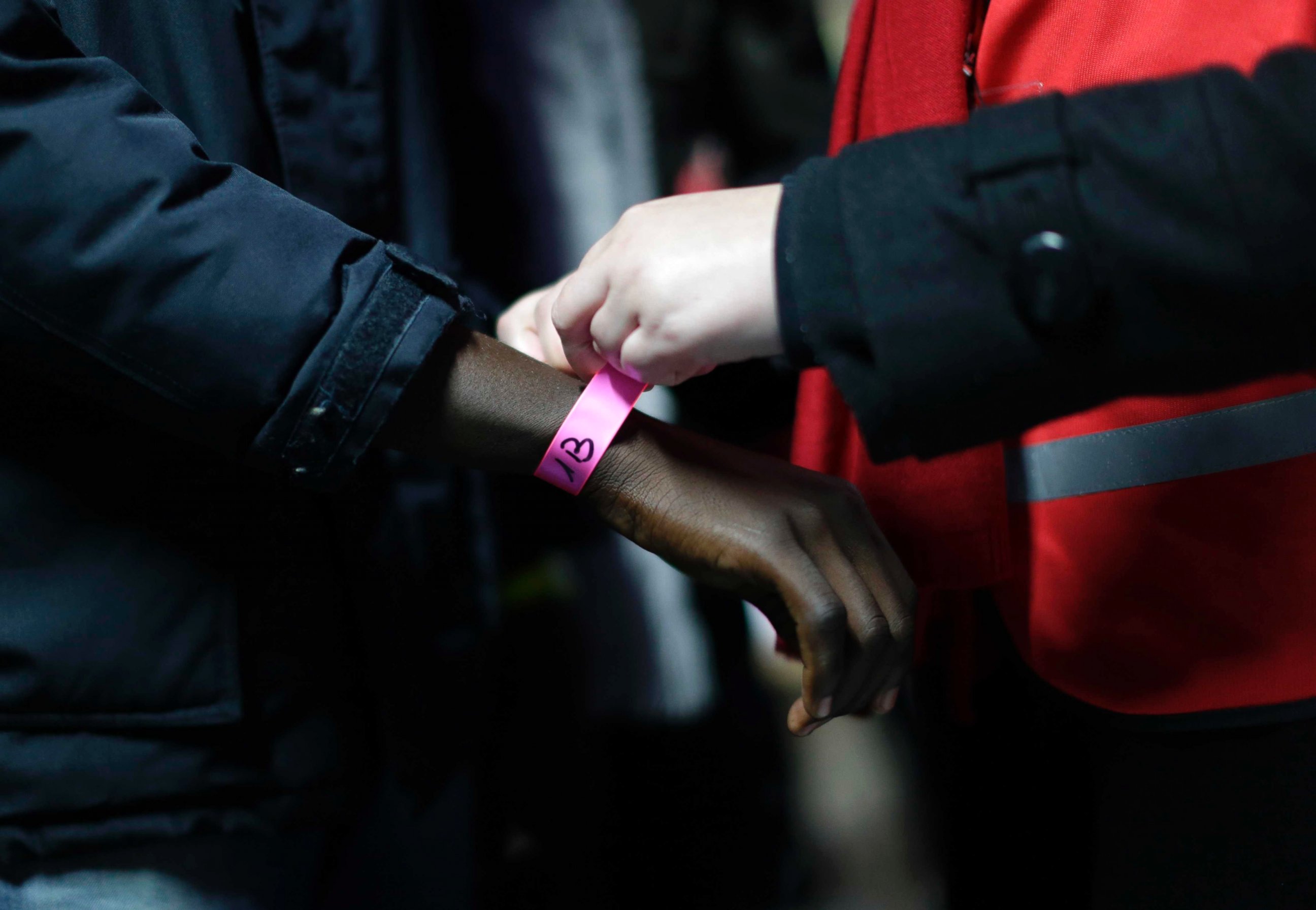PHOTO: A wristband is attached to a migrant at a processing center in the migrant camp known as "the Jungle" near Calais, northern France, Oct. 24, 2016.