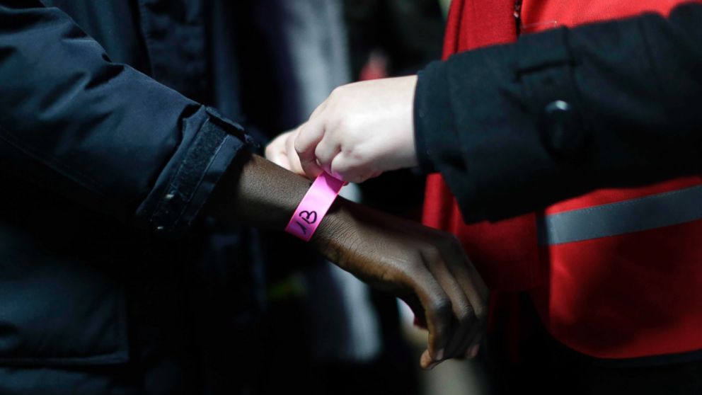 PHOTO: A wristband is attached to a migrant at a processing center in the migrant camp known as "the Jungle" near Calais, northern France, Oct. 24, 2016.