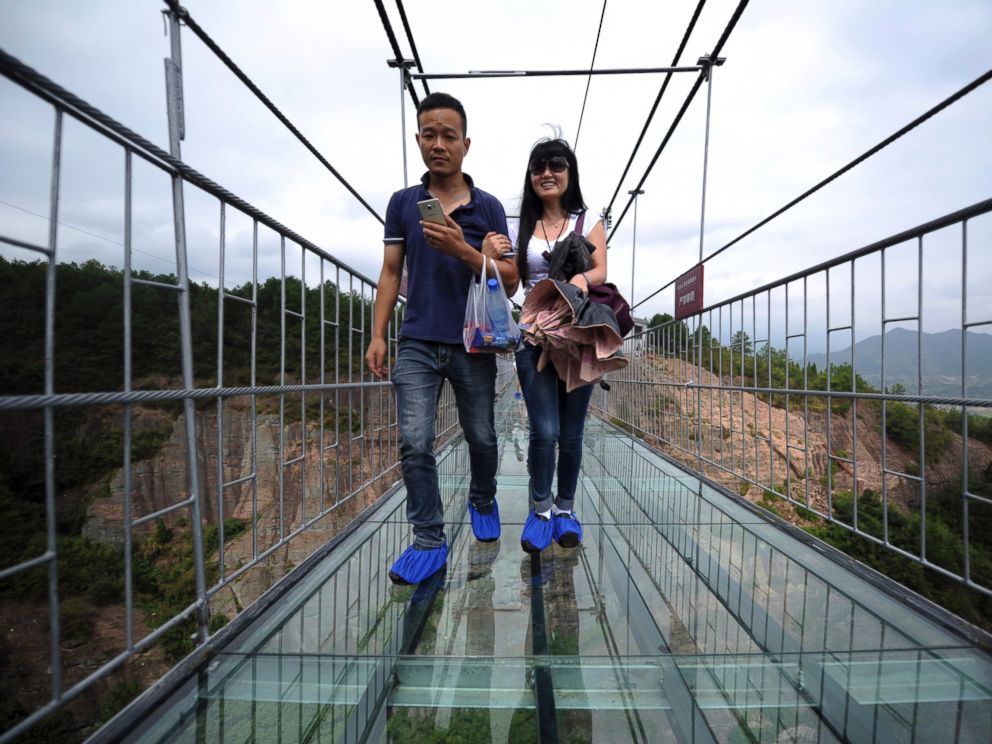 China Opens 600-Feet-High Glass-Bottomed Bridge in Canyon That Inspired ...