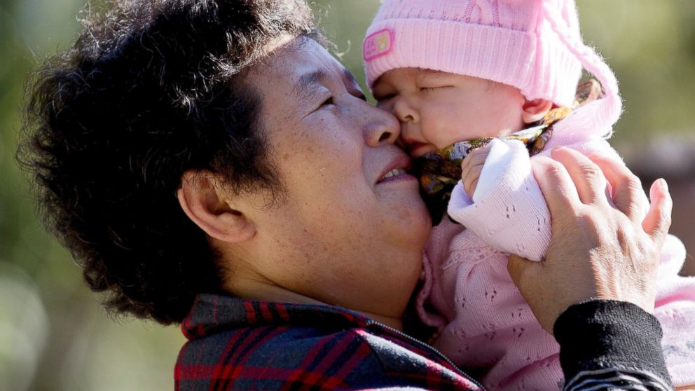 PHOTO: A woman plays with her grandchild at the Ritan Park in Beijing.