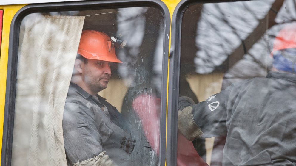 Miners sit on a bus after an explosion at the Zasyadko coal mine in Donetsk, Ukraine, March 4, 2015.