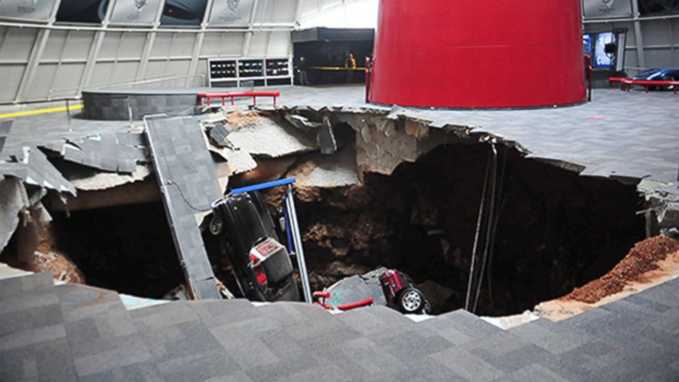 In this image provided by the National Corvette Museum shows several cars that collapsed into a sinkhole, Feb. 12, 2014, in Bowling Green, Ky. The museum said a total of eight cars were damaged when a sinkhole opened up early Wednesday morning inside the museum.