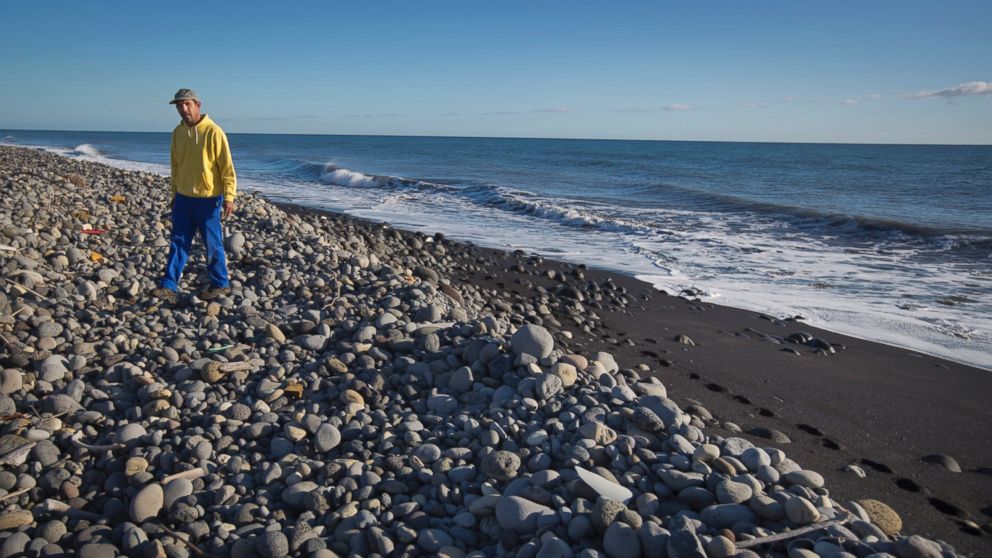 Johnny Begue, 46, who says he found the piece of aircraft debris that is being investigated, walks on Bois-Rouge beach where the debris was washed up, near to Saint-Andre on the north coast of the Indian Ocean island of Reunion, July 31, 2015.