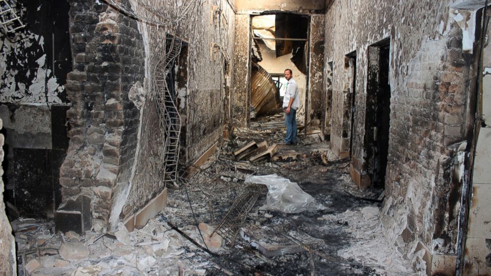 In this Oct. 16, 2015, file photo, an employee of Doctors Without Borders stands inside the charred remains of their hospital after it was hit by a U.S. airstrike in Kunduz, Afghanistan on Oct. 3, 2015. 