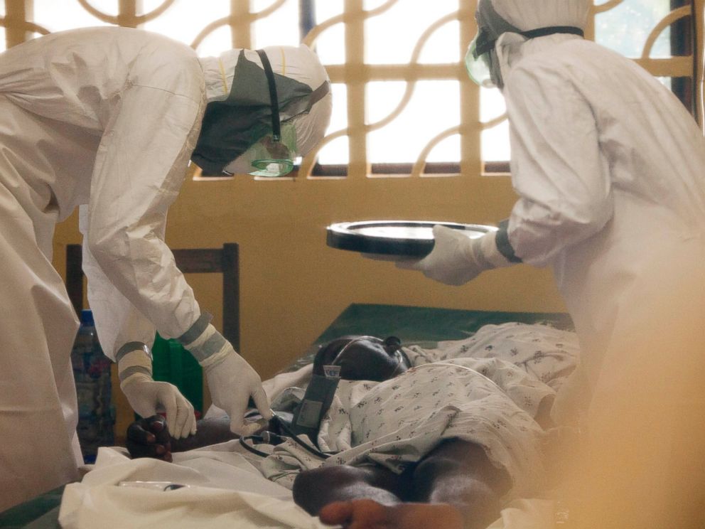 PHOTO: Dr. Kent Brantly, seen at left treating an Ebola patient in Liberia this year, has now become one of two Americans known to have been infected with the disease.