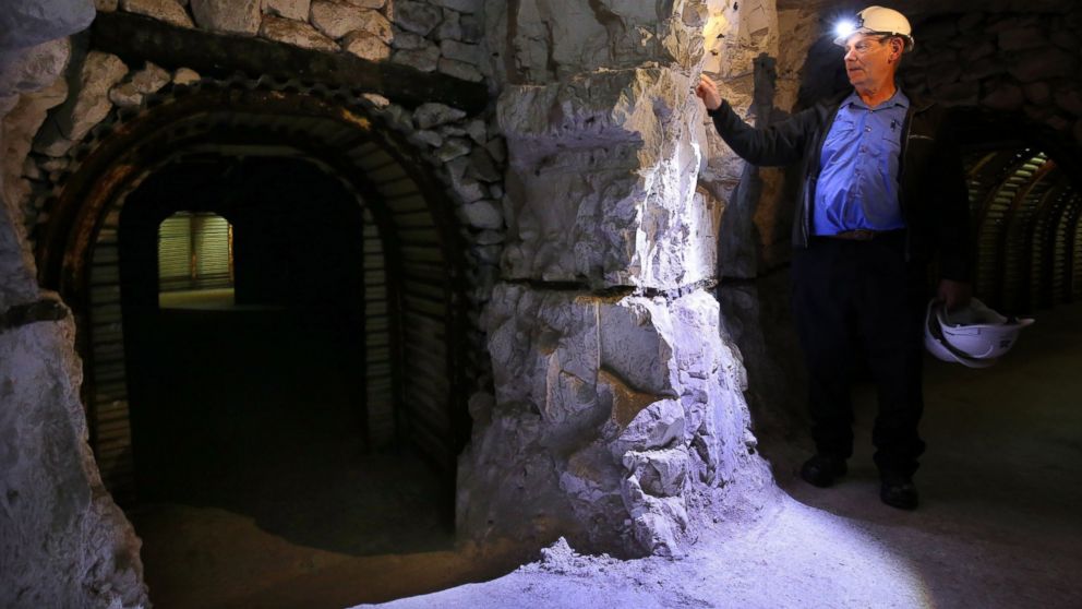 National Trust volunteer Gordon Wise exploring the tunnels of the Fan Bay Deep Shelter, July 15, 2015, in Dover, Kent.