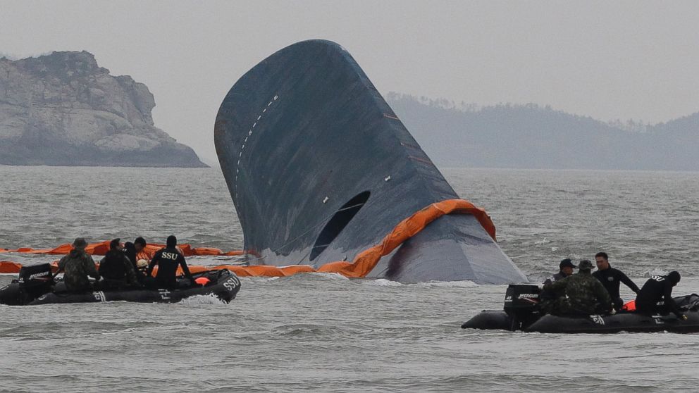 Coast Guard officers search for missing passengers aboard a sunken ferry in the water off the coast of South Korea, April 17, 2014.