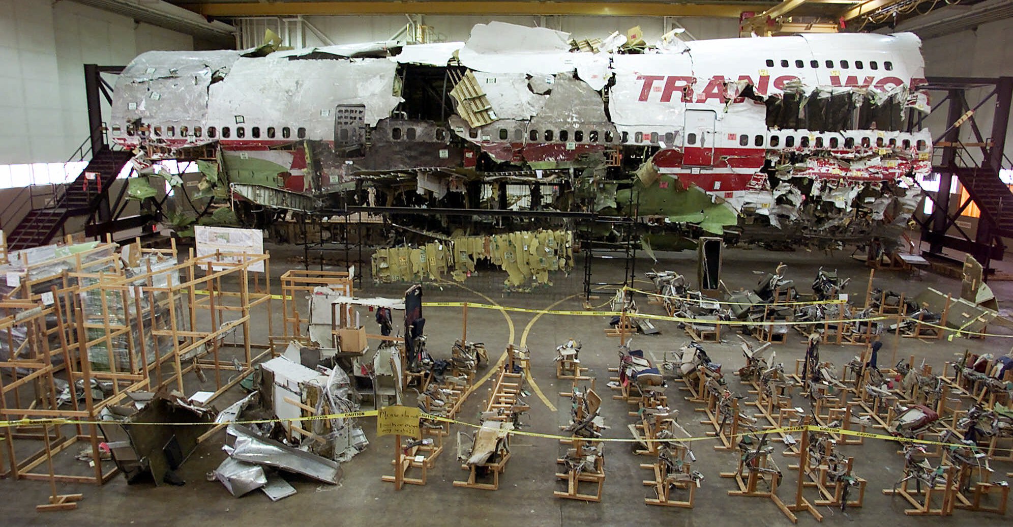 PHOTO: The seats, foreground, and the wreckage of TWA Flight 800 sit in a hangar in Calverton, N.Y. on July 16, 2001.