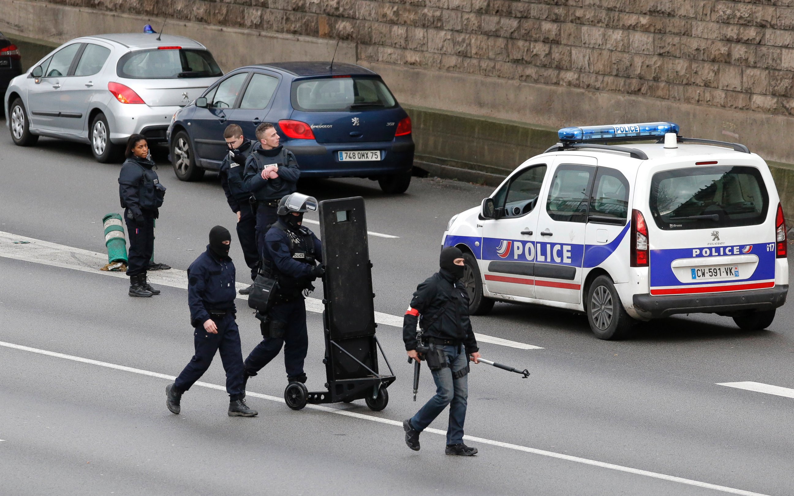 PHOTO: Hooded police officers walk on the closed ring road that circles Paris near a hostage-taking situation at a kosher market in Paris, Jan.9, 2015.