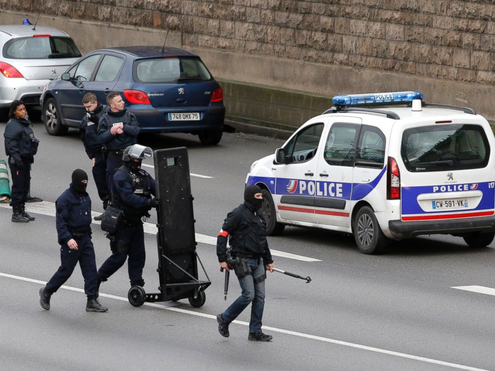 PHOTO: Hooded police officers walk on the closed ring road that circles Paris near a hostage-taking situation at a kosher market in Paris, Jan.9, 2015.