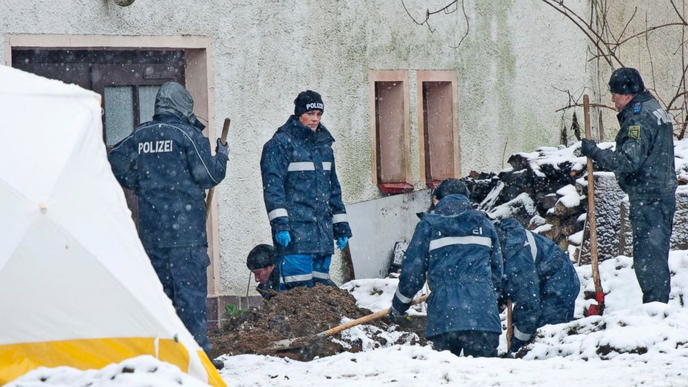 Police investigate the area around a house near Reichenau, south of Dresden, eastern Germany, Nov. 30, 2013.