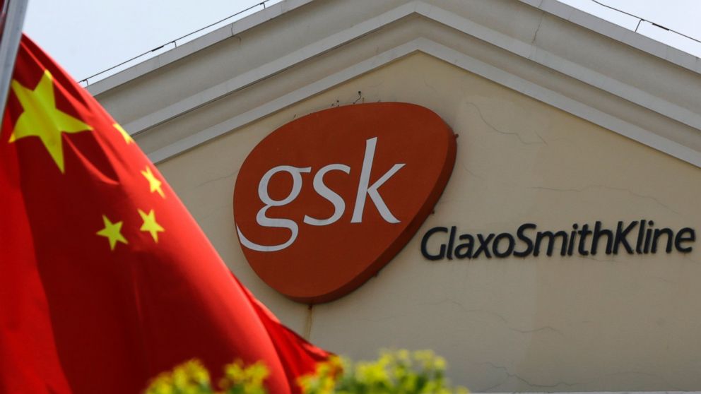 A Chinese flag is hoisted in front of a GlaxoSmithKline building in Shanghai, China, July 24, 2013.