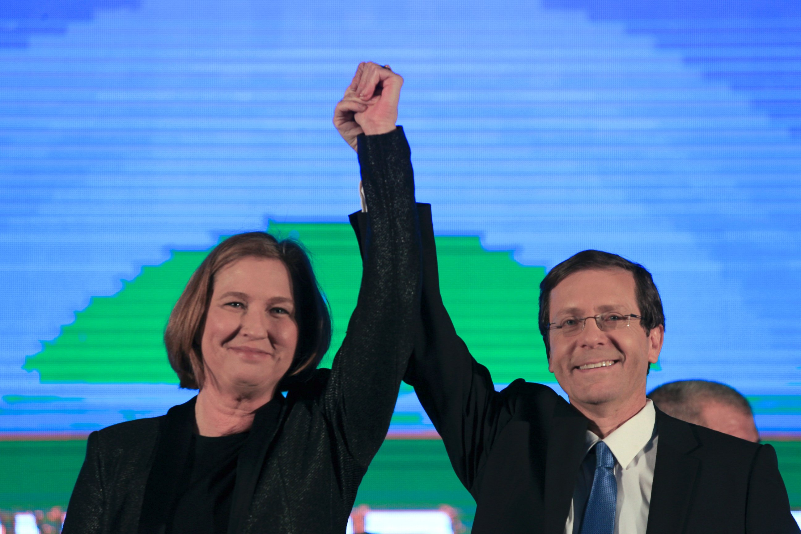 PHOTO: Zionist Union party co-leadesr Isaac Hezcog, right, and Tzipi Livni greet supporters at the party's election headquarters in Tel Aviv, March 18, 2015.