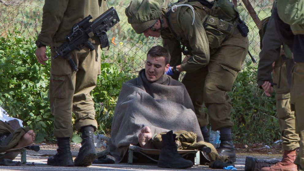 Israeli soldiers treat a wounded soldier near the Israel-Lebanon border on Jan. 28, 2015. 