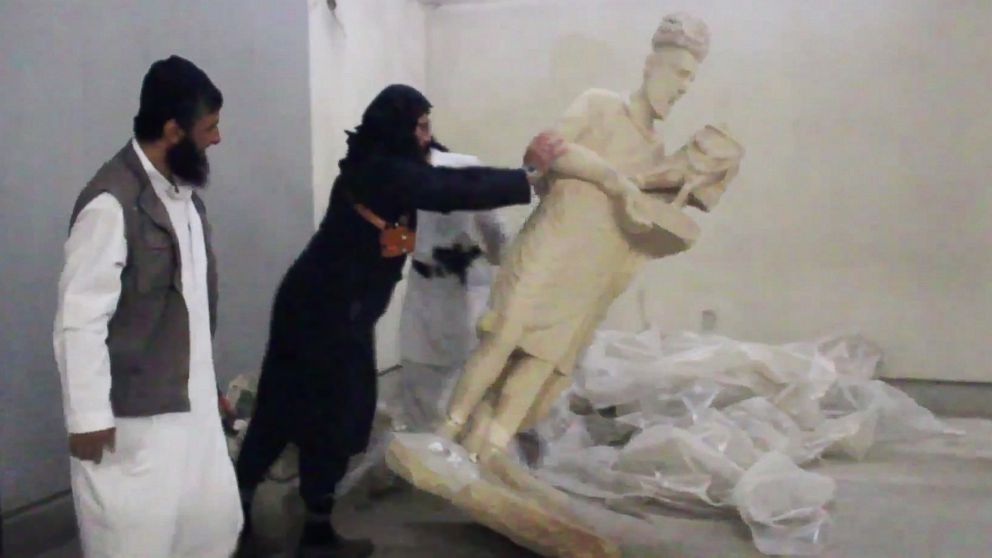 PHOTO: A militant topples an ancient artifact in the Ninevah Museum in Mosul, Iraq, in this screengrab from a video posted on a social media account affiliated with the Islamic State group on Feb. 26, 2015.