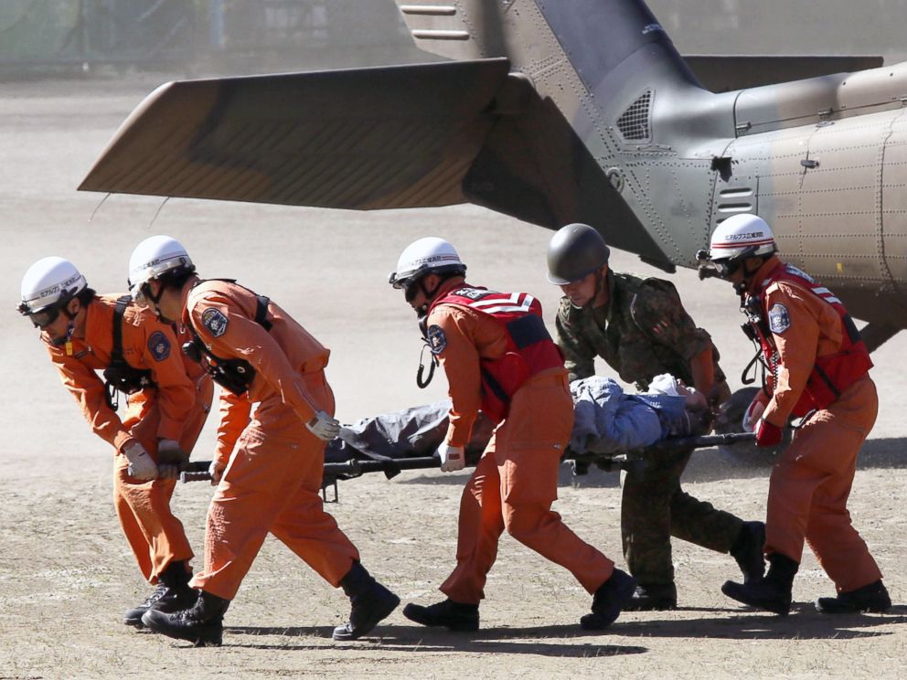 PHOTO: Rescue workers carry a climber rescued from Mount Ontake into an ambulance, in Kiso, Nagano prefecture in central Japan, Sept. 28, 2014.