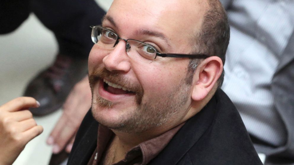 In this photo April 11, 2013 file photo, Jason Rezaian, an Iranian-American correspondent for the Washington Post, smiles as he attends a presidential campaign of President Hassan Rouhani, in Tehran, Iran.  