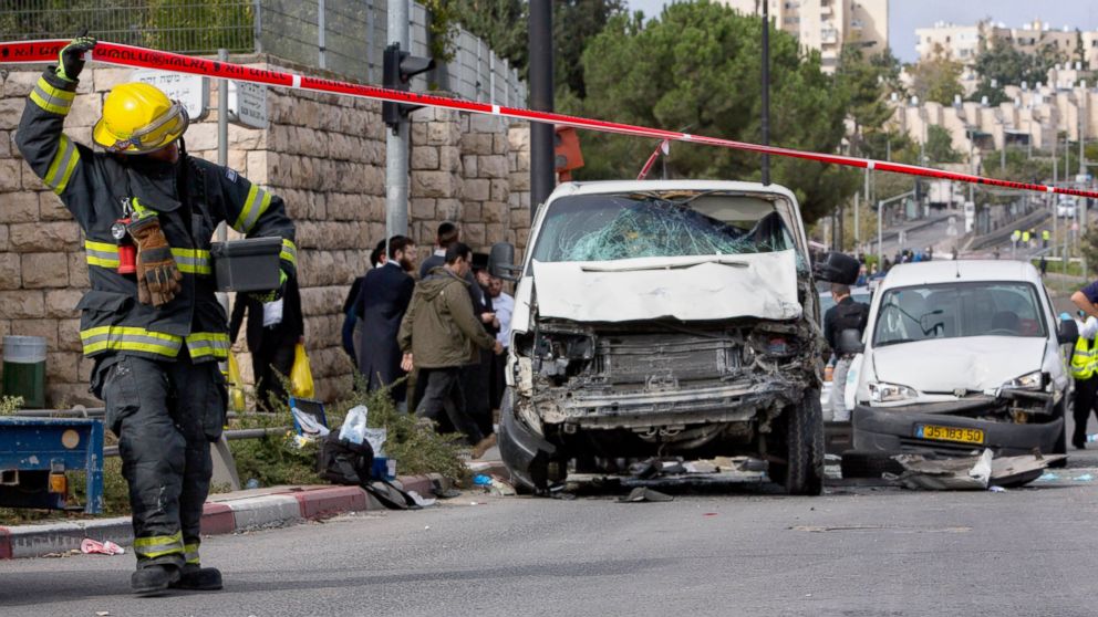 An Israeli fire fighter walks at the scene of an attack in Jerusalem, Nov. 5, 2014. 