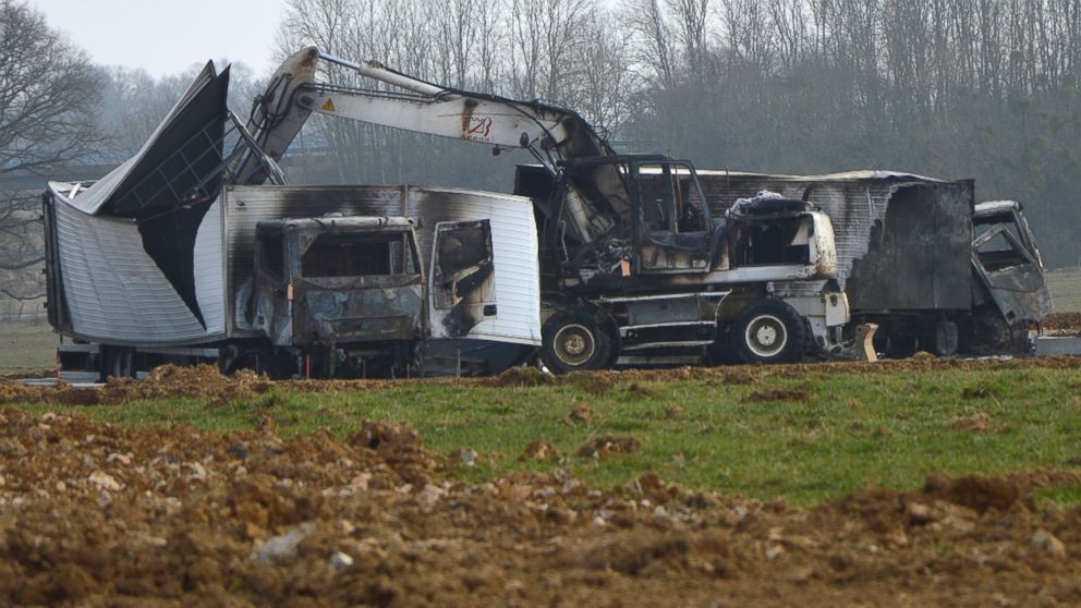 Burnt out vans are seen near the Avallon motorway exit, in central France, on March 11, 2015. 