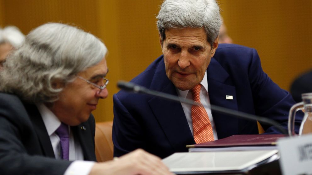 Secretary of State John Kerry talks to Secretary of Energy Ernest Moniz, left, during a plenary session at the United Nations building in Vienna, Austria, July 14, 2015. 
