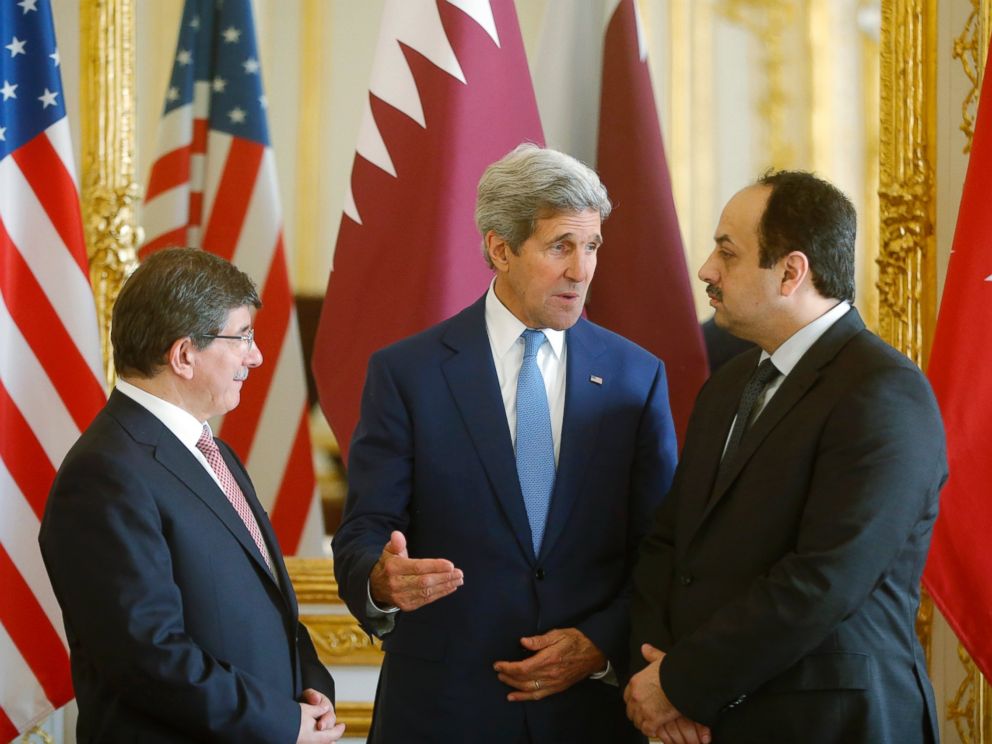 PHOTO: U.S. Secretary of State John Kerry, center, speaks with Qatari Foreign Minister Khaled al-Attiyah, right, and Turkish Foreign Minister Ahmet Davutoglu on July 26, 2014 in Paris.