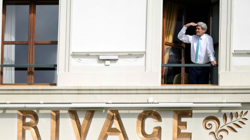 John Kerry looks at the view of Lake Geneva from his hotel room as the Iran nuclear talks continue in Lausanne, Switzerland, April 1, 2015.