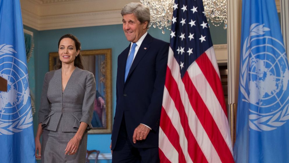 Secretary of State John Kerry, right, with United Nations High Commissioner for Refugees Special Envoy Angelina Jolie walks to the Treaty Room at the Department of State in Washington, June 20, 2016. UNHCR Special Envoy Angelina Jolie Pitt called for action on World Refugee Day.