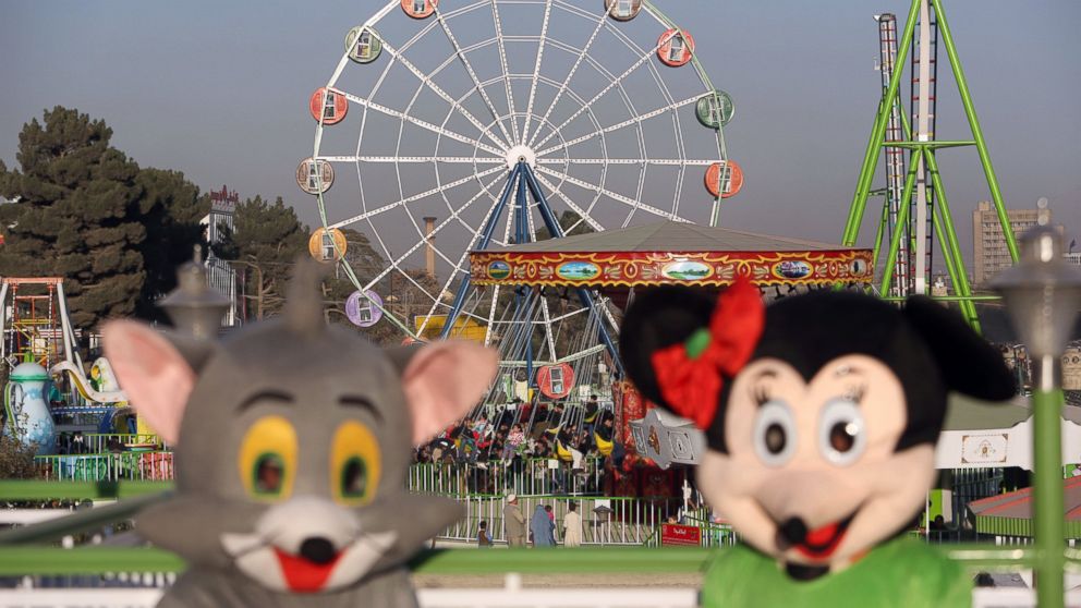 Characters that resemble Jerry the mouse from Tom and Jerry and Minnie Mouse welcome visitors at Afghanistan's first amusement park called City Park in Kabul, Nov. 114, 2014. 