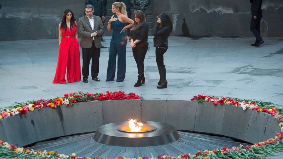 Kim Kardashian, left, and her sister Khloe Kardashian, center, visit the memorial to the victims of genocide in Yerevan, Armenia, April 10, 2015. 