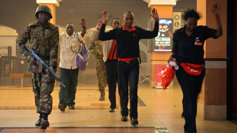 Kenya Civilians who had been hiding during a gun battle hold their hands in the air as a precautionary measure before being searched by armed police leading them to safety, inside the Westgate Mall, Sept. 21, 2013.