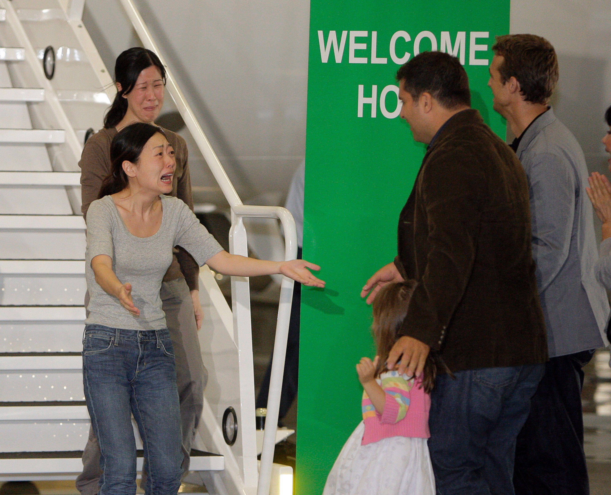 PHOTO: Euna Lee, left, and Laura Ling, two American journalists who were arrested in March after allegedly crossing into North Korea from China, are greeted after the two arrive at Bob Hope Airport in Burbank, Calif., Aug. 5, 2009.